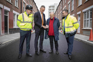 Michael McLoughlin, contracts director at Riney, Roger Eke, technical product support manager at Tarmac, John Biggs, mayor of Tower Hamlets, and Stephen Warway, highways engineer at Tower Hamlets council, inspect the new rubber road at Canrobert Street in Bethnal Green.