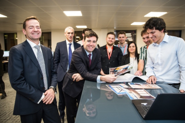 Greater Manchester mayor Andy Burnham with WSP staff looking over the homeless shelter prototype designs during the firm's new office opening in Manchester.