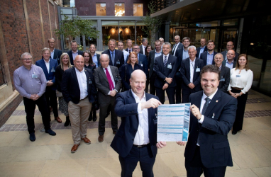 National Highways chief executive Nick Harris and prof Ioannis Brilakis of the University of Cambridge hold the signed charter with representatives from the other partners in the new alliance.