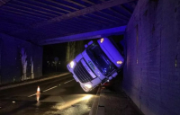 A lorry stuck under the railway bridge