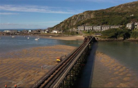 Barmouth viaduct to reopen to festive walkers as engineers work around clock to restore timber structure.