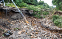 Network Rail are working around-the-clock to repair extensive flood damage on the Edinburgh-Glasgow line, which could see the line out of action for two months.
